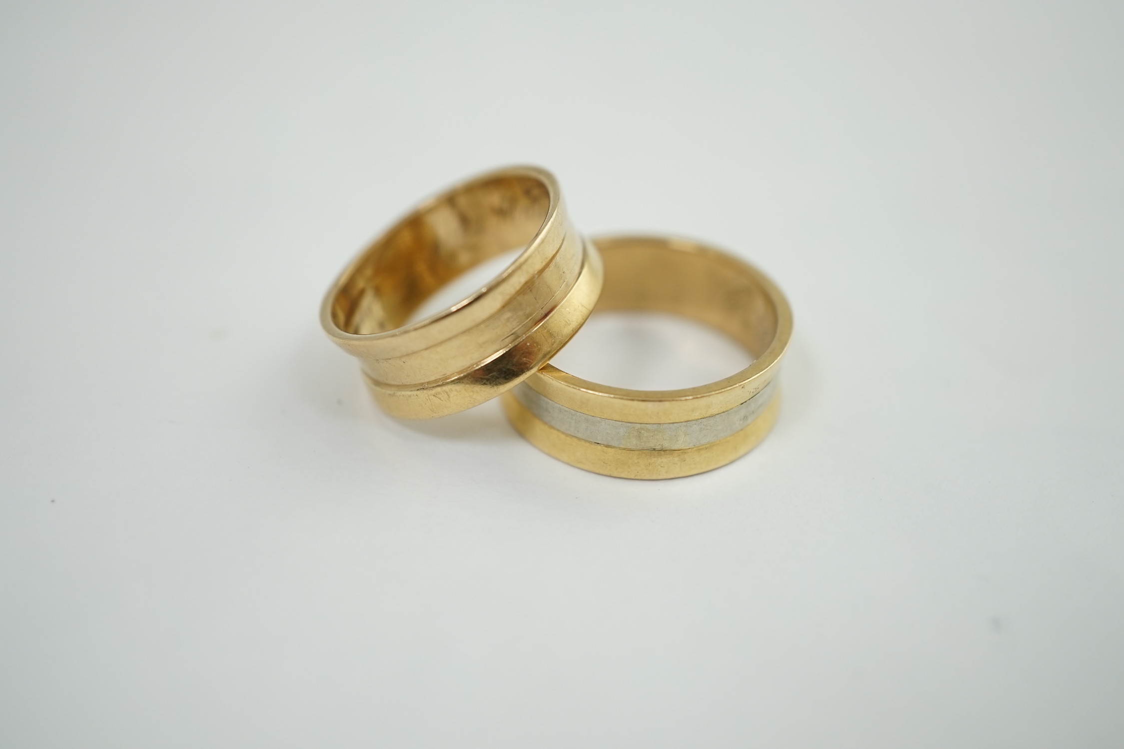 A lady's and gentleman's gold wedding bands, the latter with central white gold band